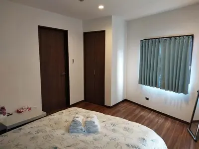 a bedroom with a bed with white shoes on it at \u611b\u306e\u5c4b\u6c11\u6cca\u6c60\u888b in Tokyo