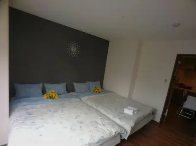 a bedroom with a bed with yellow flowers on it at \u611b\u306e\u5c4b\u6c11\u6cca\u6c60\u888b in Tokyo