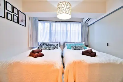 two beds in a room with a window at LCE203 6min Shimo Sta 13min Akabane Max 8 in Tokyo