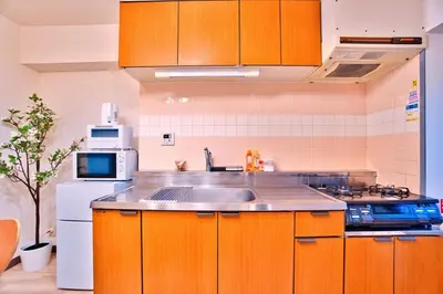 a kitchen with orange cabinets and a sink and a refrigerator at LCE203 6min Shimo Sta 13min Akabane Max 8 in Tokyo