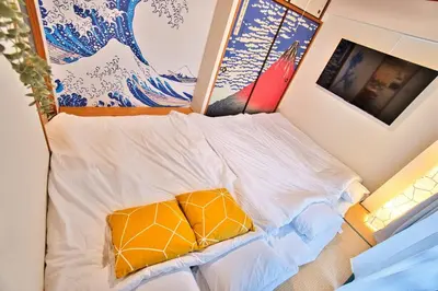 a small bed with a yellow pillow in a room at LCE203 6min Shimo Sta 13min Akabane Max 8 in Tokyo