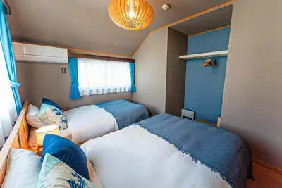 a small bedroom with two beds and a window at Third Place Tokyo - Aoto - in Tokyo