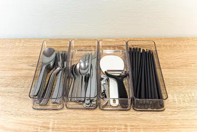 a plastic container with utensils on a table at Third Place Tokyo - Aoto - in Tokyo