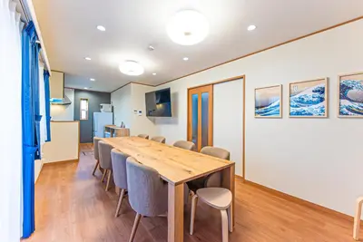 a conference room with a wooden table and chairs at Third Place Tokyo - Aoto - in Tokyo
