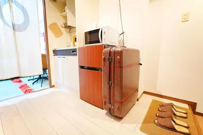 a kitchen with a refrigerator and a microwave at 1 stop from Shinjuku, 3 minutes, Japanese-style room, with balcony, Japanese modern in Tokyo