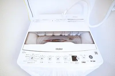 a white washing machine sitting on a wall at 1 stop from Shinjuku, 3 minutes, Japanese-style room, with balcony, Japanese modern in Tokyo