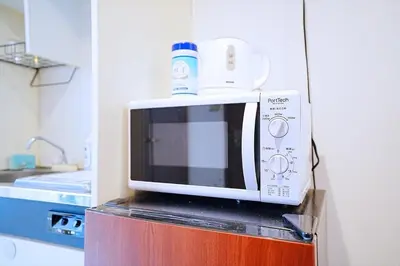 a microwave oven sitting on top of a counter at 1 stop from Shinjuku, 3 minutes, Japanese-style room, with balcony, Japanese modern in Tokyo