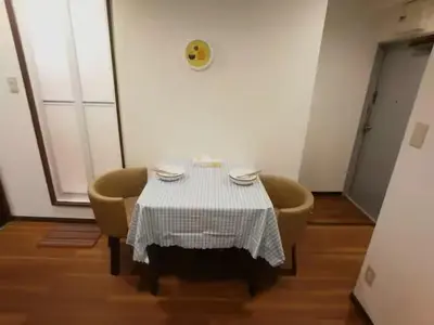 a table in a room with two chairs and a table with a tablecloth at \u611b\u306e\u5c4b\u30db\u30c6\u30eb\u58a8\u7530 in Tokyo