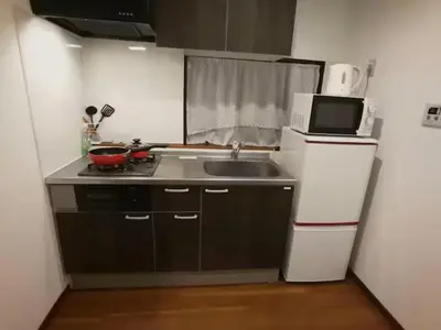 a small kitchen with a sink and a refrigerator at \u611b\u306e\u5c4b\u30db\u30c6\u30eb\u58a8\u7530 in Tokyo