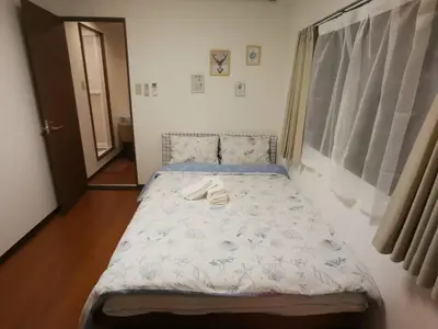 a small bed in a room with a window at \u611b\u306e\u5c4b\u30db\u30c6\u30eb\u58a8\u7530 in Tokyo