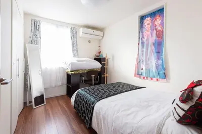 a small bedroom with a bed and a window at Omorikita 4chome House in Tokyo