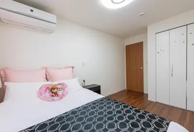 a bedroom with a large bed with a donut on it at Omorikita 4chome House in Tokyo