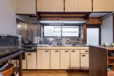 a large kitchen with a sink and a stove at comin in Tokyo