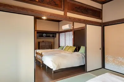 a bedroom with a bed and a sliding glass door at comin in Tokyo