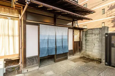 a building with a screen on the side of it at comin in Tokyo