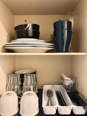 a shelf with plates and utensils in a kitchen at 6min Shibuya Station 4 Max A165 in Tokyo
