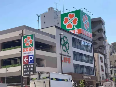 a building with signs on the side of it at 202 Yamanote Line Near Ueno Newly Built Cozy Apartment in Tokyo