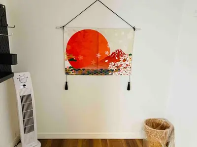 a painting hanging on a wall in a room at 202 Yamanote Line Near Ueno Newly Built Cozy Apartment in Tokyo