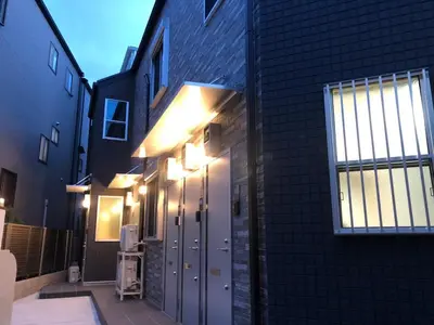 a building with lights on the side of it at 203 Yamanote Line Near Ueno Park Cozy New Apartment in Tokyo