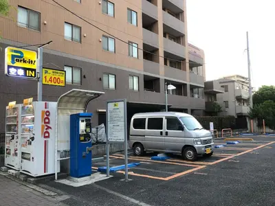 a van parked in a parking lot next to a gas station at 203 Yamanote Line Near Ueno Park Cozy New Apartment in Tokyo