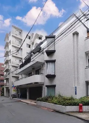 a large white building on a city street at Sunny Home Asakusa in Tokyo