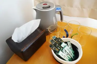 a table with glasses and a bowl of money at Japanese-Tradtional House Max 8 Guest 6-Min Walk from Station Check-out at 12 PM in Tokyo