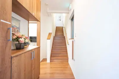 a staircase in a house with wood floors and a hallway at bai\u5965\u62382\u4e01\u76ee in Tokyo