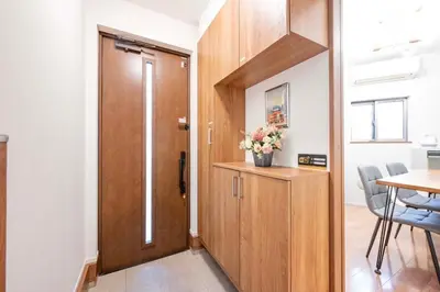 a wooden door in a room with a table and chairs at bai\u5965\u62382\u4e01\u76ee in Tokyo