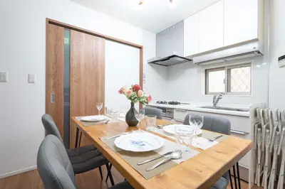 a kitchen and dining room with a wooden table and chairs at bai\u5965\u62382\u4e01\u76ee in Tokyo