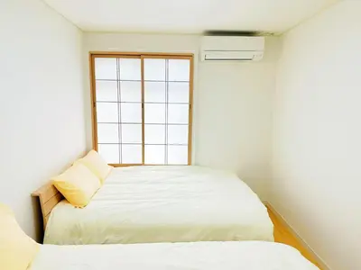 a small bedroom with a bed and a window at \u6587\u4eac\u30cf\u30a6\u30b9301 in Tokyo