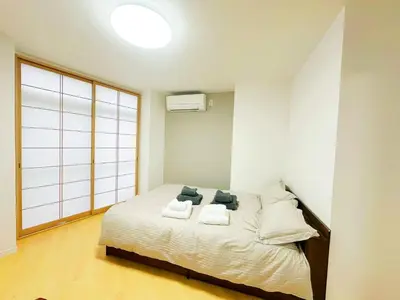 a bedroom with a bed with two pillows on it at \u6587\u4eac\u30cf\u30a6\u30b9301 in Tokyo