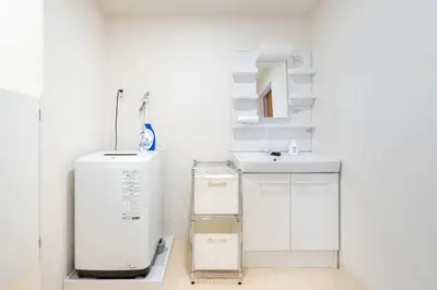 a white bathroom with a sink and a mirror at -Park Higashiueno- 4-minute walk from Ueno Station in Tokyo