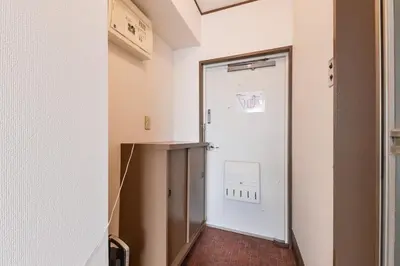 a hallway with a door leading to a room at Sakura in Tokyo