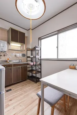 a kitchen with a table and a large window at Sakura in Tokyo