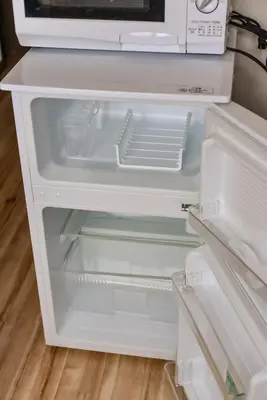 an empty refrigerator with its door open in a kitchen at Sakura in Tokyo