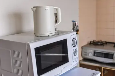 a blender sitting on top of a microwave at Sakura in Tokyo