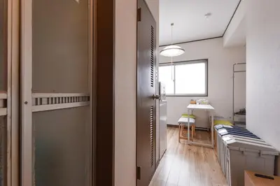 a kitchen with a door leading to a dining room at Sakura in Tokyo