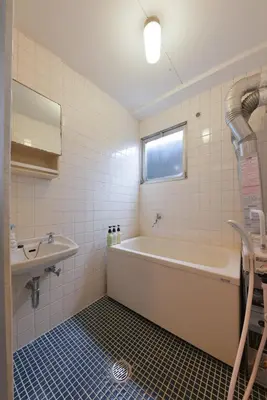 a bathroom with a bath tub and a sink at Sakura in Tokyo