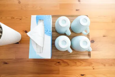 a group of white vases on a wooden table at 67LEREVE Ikebukuro in Tokyo