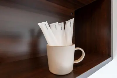 a white cup filled with white paper straws at LIVCITY Kinshicho 701 in Tokyo