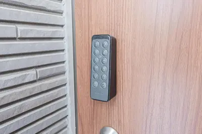 a remote control sticking out of a door at Sohome Otsuka Hotel in Tokyo