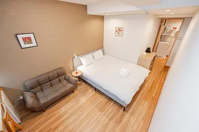 a hospital room with a bed and a couch at Sohome Otsuka Hotel in Tokyo