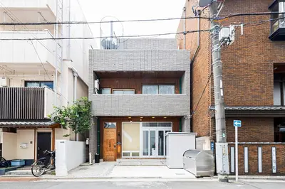 a brick building with a door on a street at KS Mukoujima in Tokyo