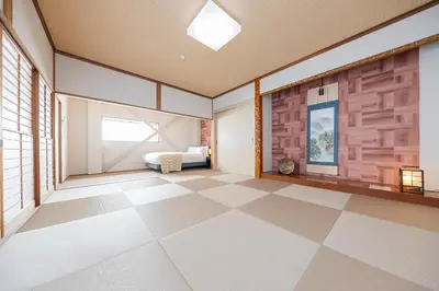 an empty room with a bed and a tiled floor at KS Mukoujima in Tokyo