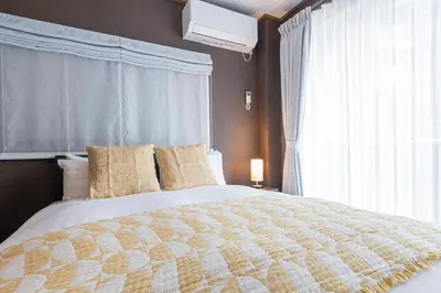a bedroom with a large bed with a window at KS Mukoujima in Tokyo