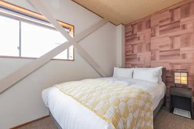 a bedroom with a bed in a room with a window at KS Mukoujima in Tokyo