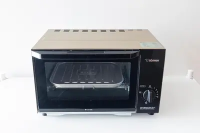 a toaster oven with its door open on a counter at KS Mukoujima in Tokyo