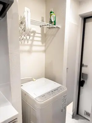 a small laundry room with a washer and dryer at 3mins to Oshiage station and Tokyo Skytree in Tokyo