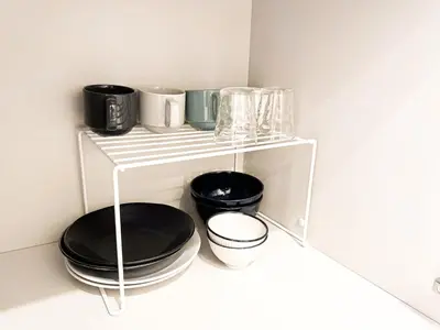 a white shelf with black plates and pans on it at 3mins to Oshiage station and Tokyo Skytree in Tokyo