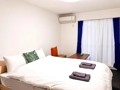 a bedroom with a white bed and a window at 3mins to Oshiage station and Tokyo Skytree in Tokyo